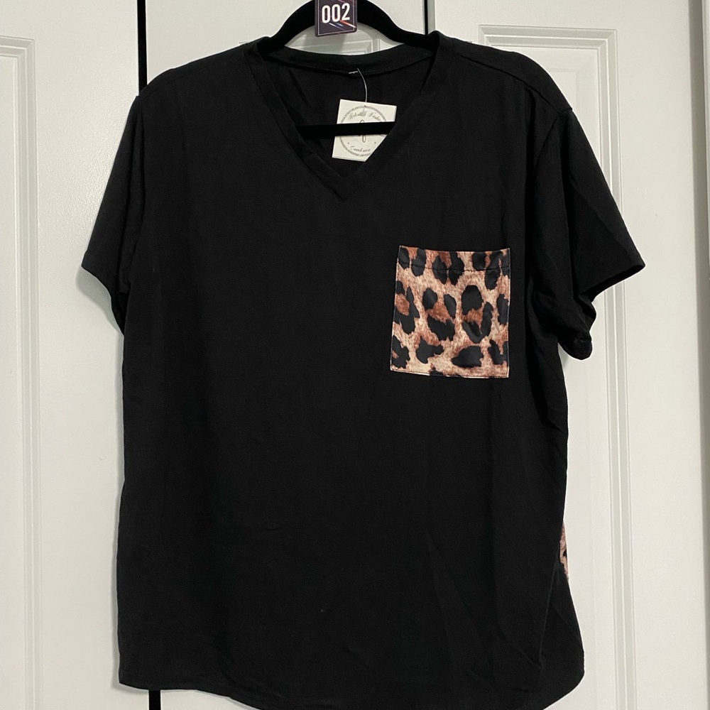 Black top with leopard print back.